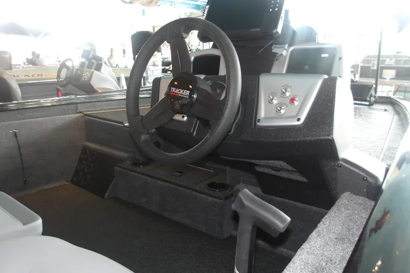 Slide: The Image of 2026 Tracker Pro Team 175 Crappie Edition boat interior with steering wheel and control panel. - 20