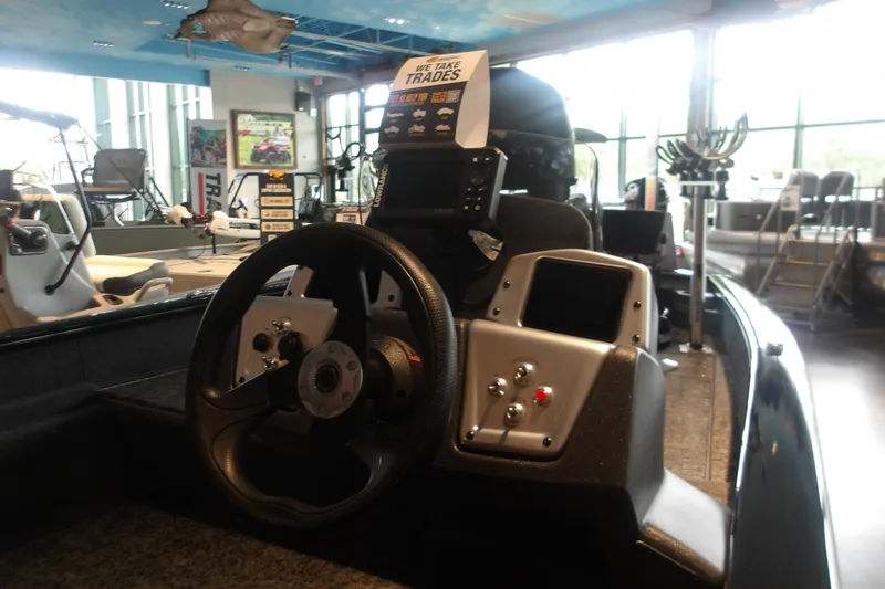 Slide: The Image of 2026 Tracker Pro Team 175 Crappie Edition boat interior with steering wheel and control panel. - 6