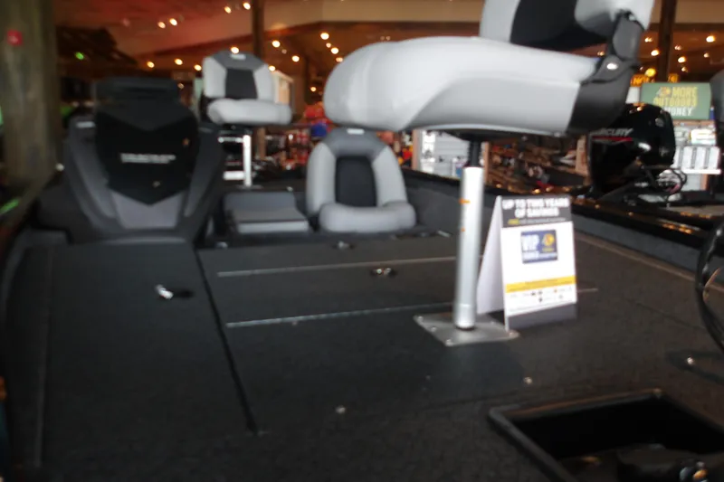 Slide: The Image of 2026 Tracker Pro Team 175 Crappie Edition boat interior with seating and display sign. - 24