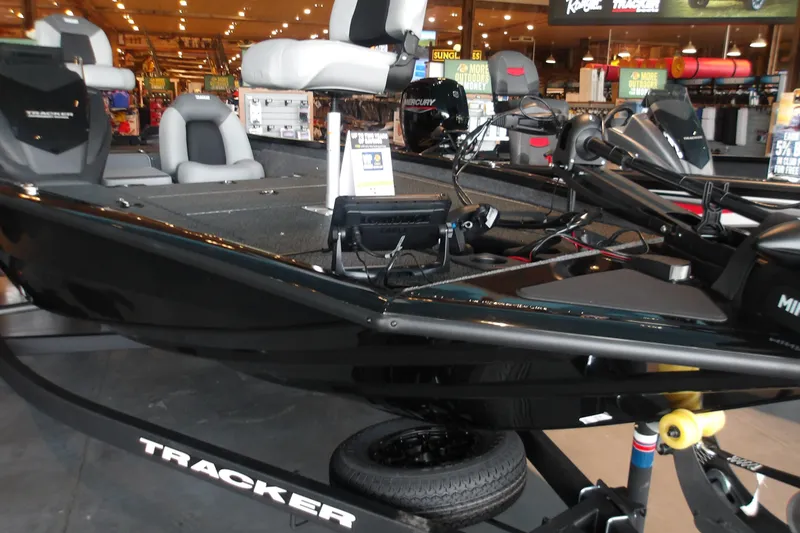 Slide: The Image of 2026 Tracker Pro Team 175 Crappie Edition boat displayed in a showroom setting. - 16