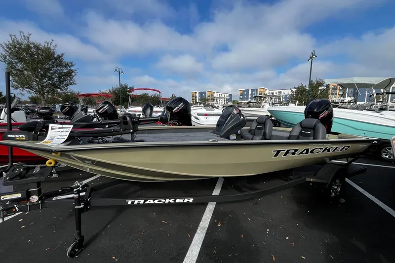 The Image of 2026 Tracker Pro Team 190 boat displayed in a parking lot under a blue sky. - 0
