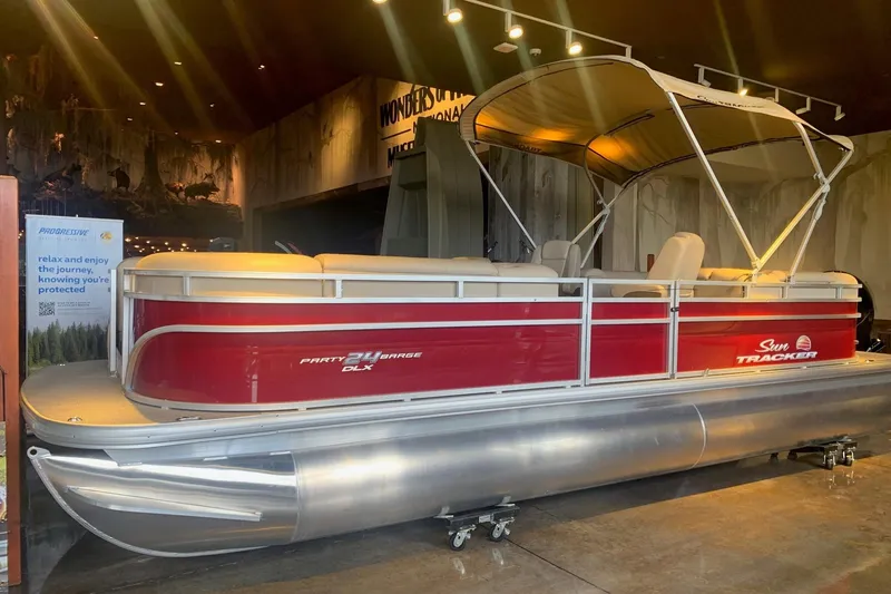 The Image of 2025 Sun Tracker Party Barge 24 DLX pontoon boat displayed indoors. - 0