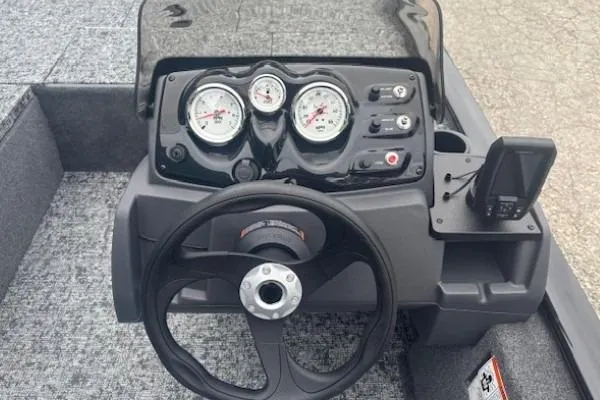 Slide: The Image of 2026 Tracker Pro 170 boat dashboard with steering wheel and gauges. - 10