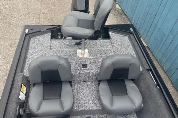 Slide: The Image of 2026 Tracker Pro 170 boat interior with three gray seats and carpeted flooring. - 11