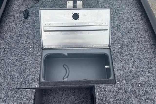 Slide: The Image of 2026 Tracker Pro 170 boat with open storage compartment on textured deck. - 7