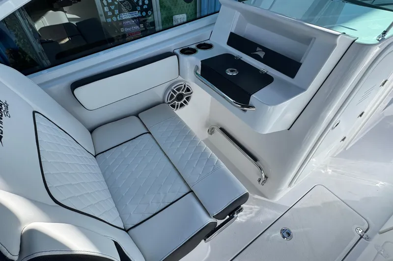 Slide: The Image of 2026 Stingray 259 DC boat interior with white seating and modern console design. - 13