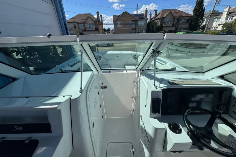 Slide: The Image of 2026 Stingray 259 DC boat interior with modern dashboard and steering wheel. - 16