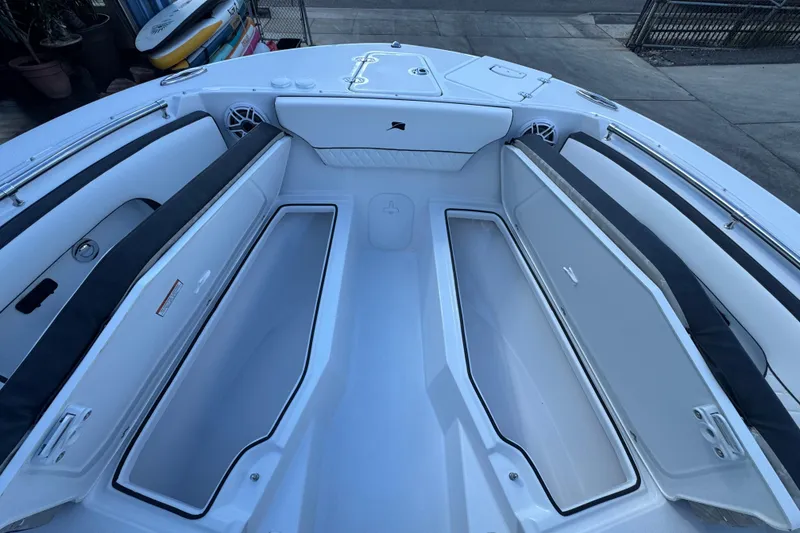 Slide: The Image of 2026 Stingray 259 DC boat interior with open storage compartments and seating. - 22