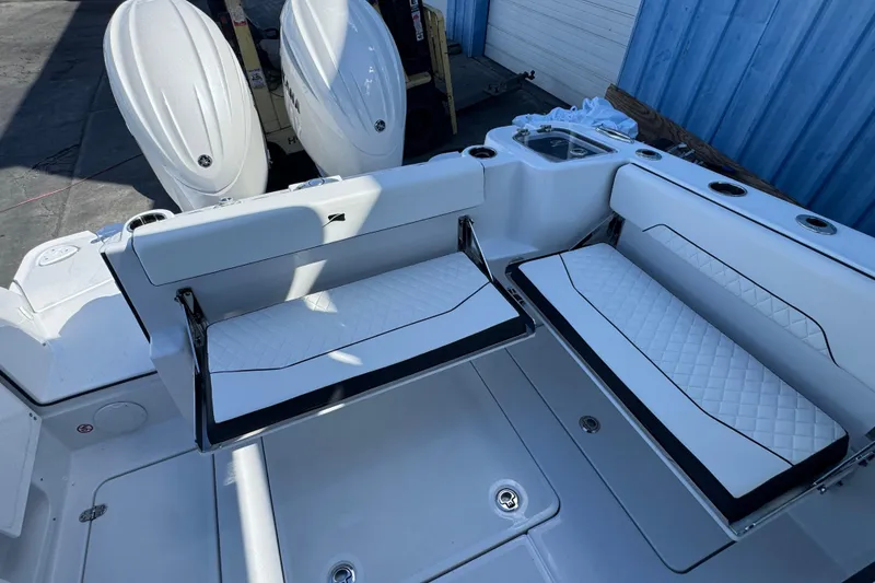 Slide: The Image of 2026 Stingray 259 DC boat interior with white cushioned seating and dual engines. - 5
