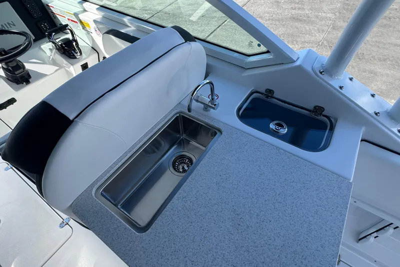 Slide: The Image of 2026 Stingray 259 DC boat interior with sink and seating area. - 7