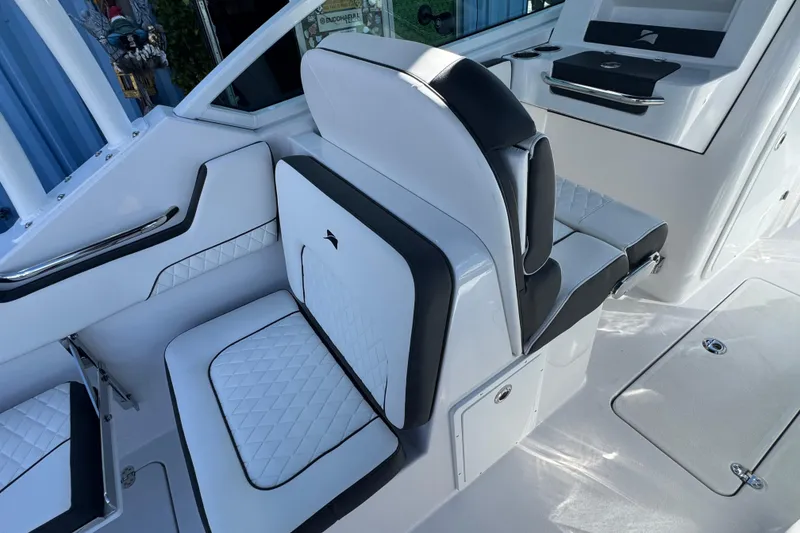 Slide: The Image of 2026 Stingray 259 DC boat interior with white and black seating, modern design. - 8