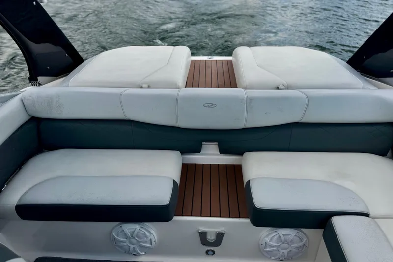 Slide: The Image of 2013 Regal 21 OBX boat interior with cushioned seating and teak flooring. - 16