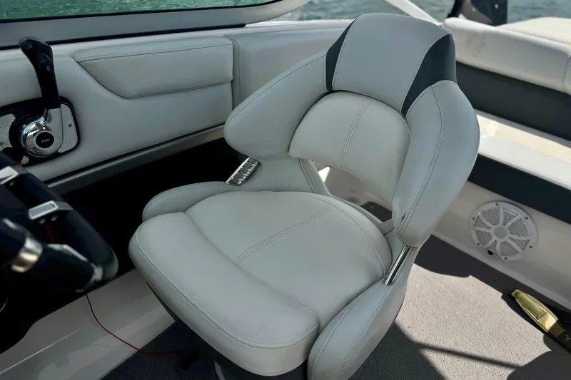 Slide: The Image of Captain's seat in 2013 Regal 21 OBX boat, featuring white upholstery and modern controls. - 4