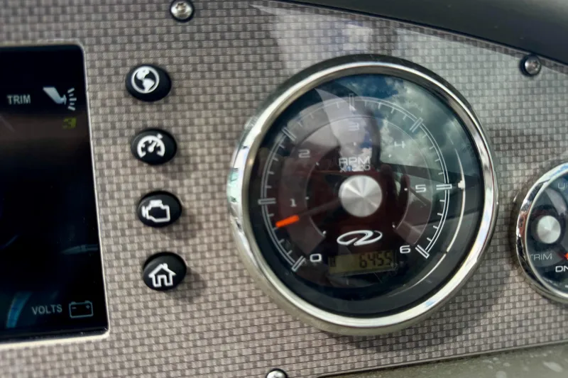 Slide: The Image of Dashboard of 2013 Regal 21 OBX boat with RPM gauge and control buttons. - 7