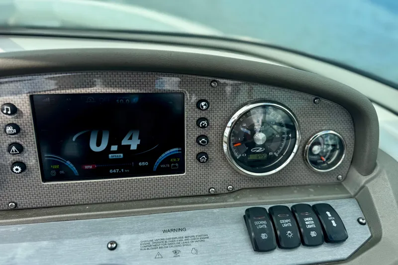 Slide: The Image of Dashboard of a 2013 Regal 21 OBX boat with digital and analog gauges. - 8