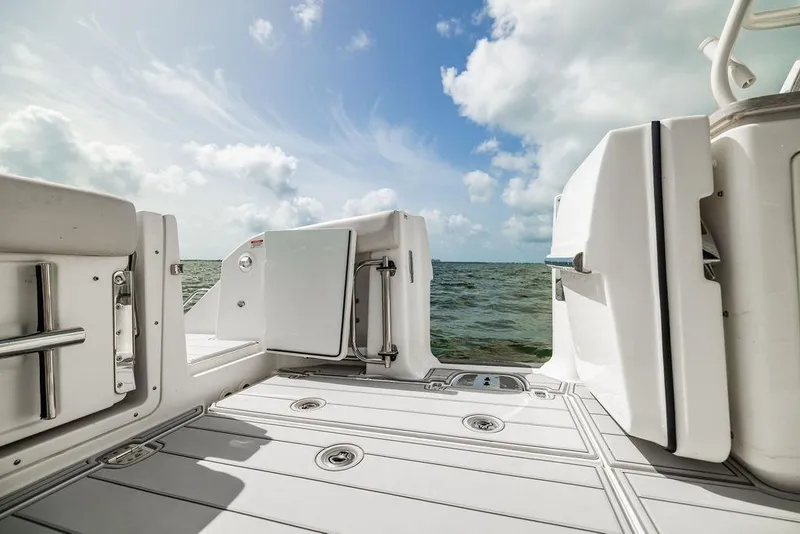 Slide: The Image of 2019 Boston Whaler 380 Realm boat deck with ocean view and open door. - 12