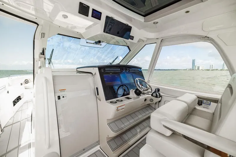 Slide: The Image of 2019 Boston Whaler 380 Realm cockpit with modern controls and ocean view. - 14