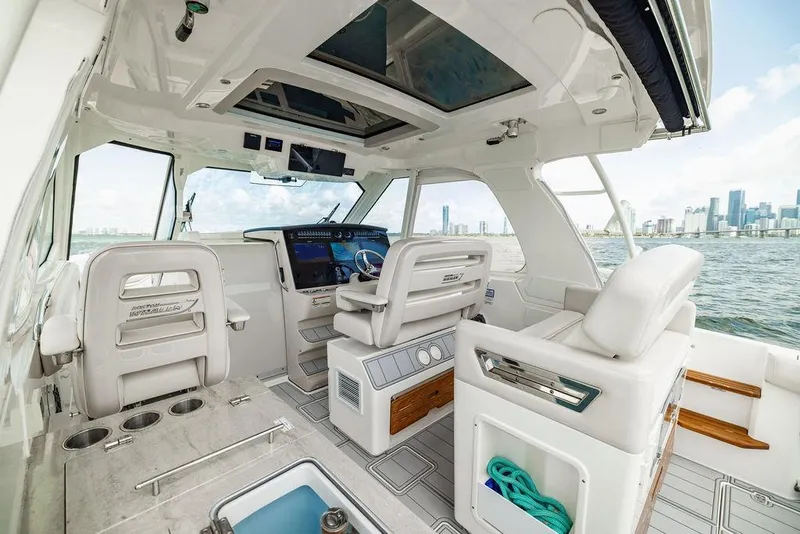 Slide: The Image of 2019 Boston Whaler 380 Realm interior with modern helm and city skyline view. - 15
