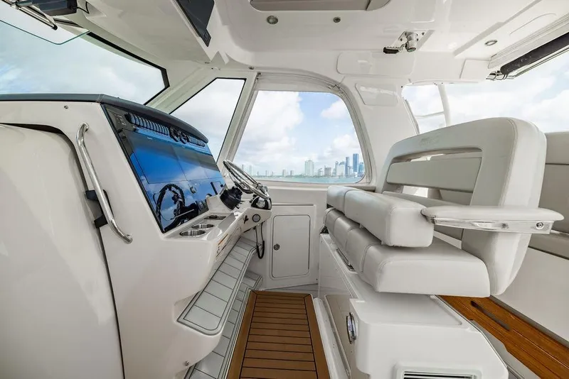 Slide: The Image of 2019 Boston Whaler 380 Realm helm with modern controls and city skyline view. - 17
