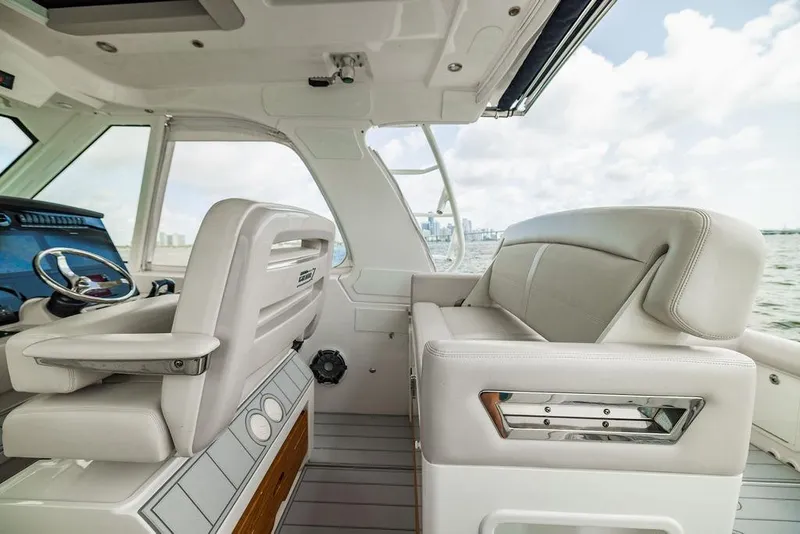 Slide: The Image of 2019 Boston Whaler 380 Realm interior with luxurious seating and modern helm. - 18
