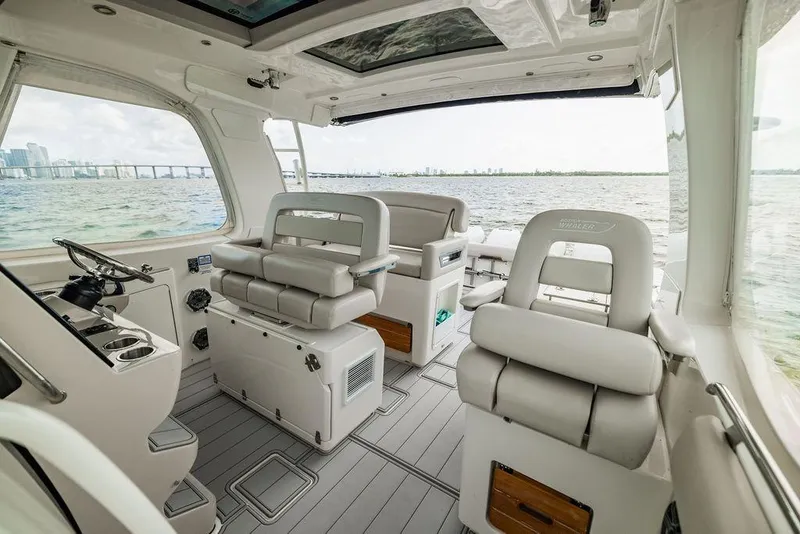 Slide: The Image of Interior of 2019 Boston Whaler 380 Realm boat with luxurious seating and ocean view. - 19