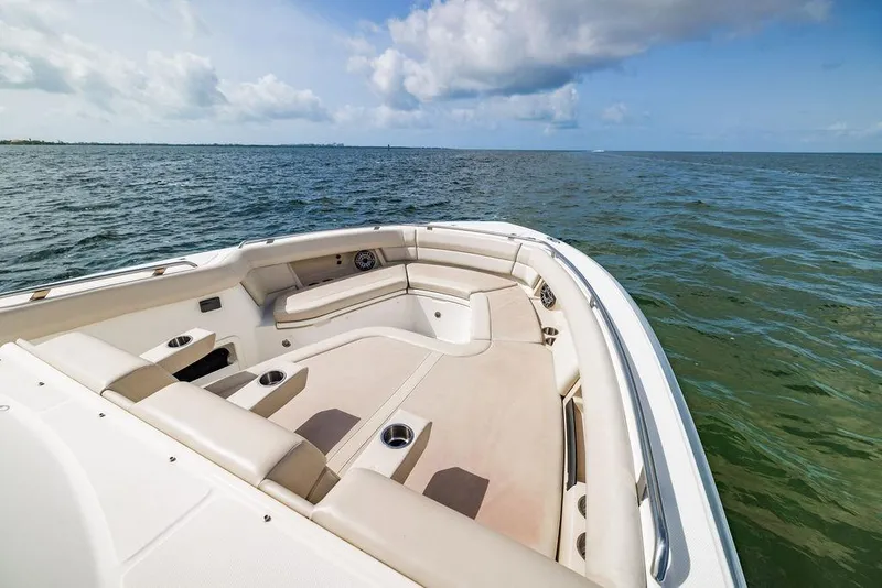Slide: The Image of 2019 Boston Whaler 380 Realm boat interior with ocean view, featuring spacious seating. - 22