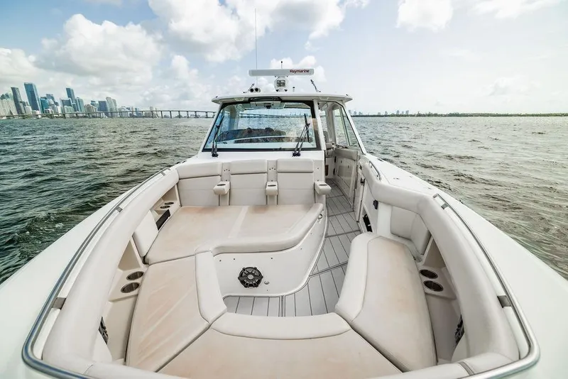 Slide: The Image of 2019 Boston Whaler 380 Realm boat interior with city skyline in background. - 23