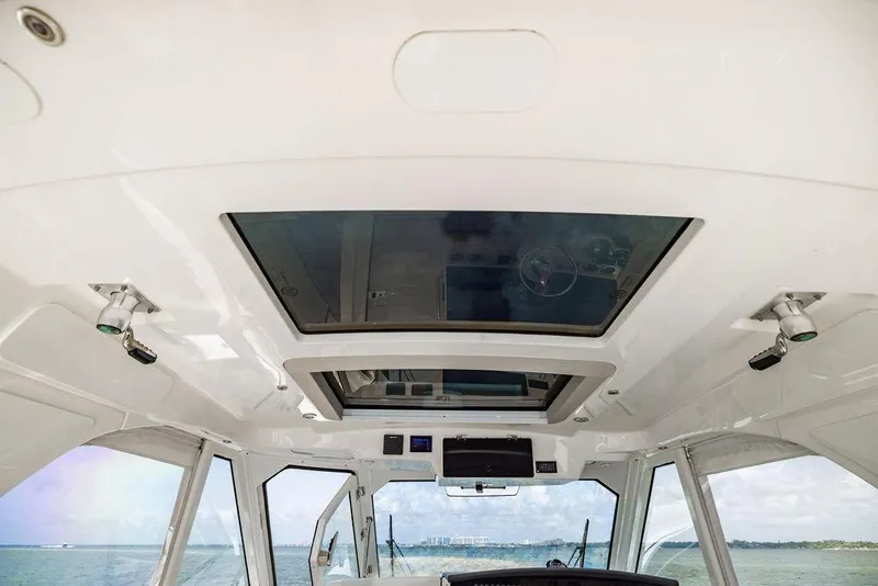 Slide: The Image of 2019 Boston Whaler 380 Realm interior with panoramic sunroof and ocean view. - 29