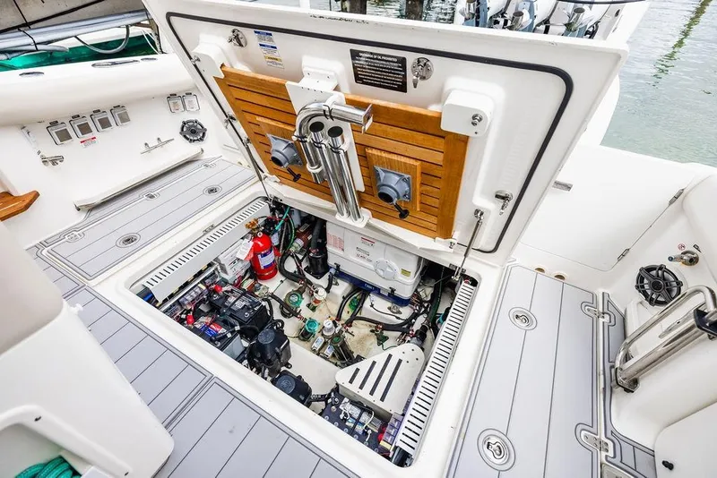 Slide: The Image of Boston Whaler 380 Realm 2019 engine compartment with equipment and fire extinguisher. - 34