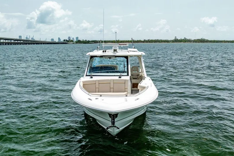Slide: The Image of 2019 Boston Whaler 380 Realm boat on open water, city skyline in background. - 37