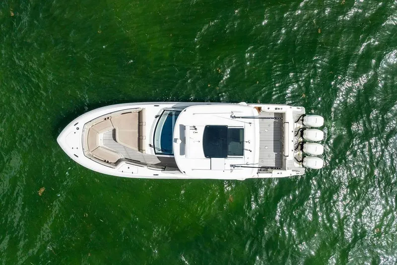 Slide: The Image of Aerial view of 2019 Boston Whaler 380 Realm on green water. - 38