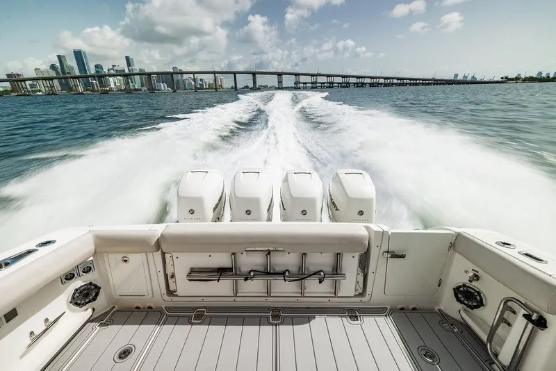 Slide: The Image of 2019 Boston Whaler 380 Realm cruising with city skyline and bridge in background. - 4