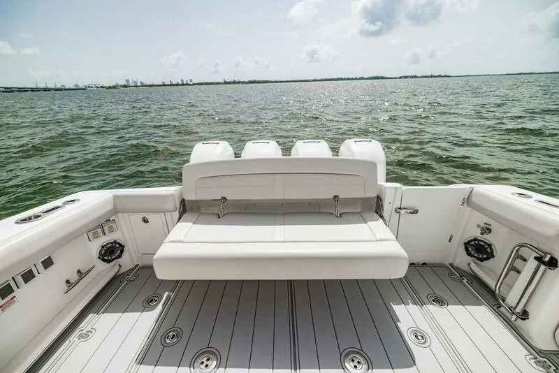 Slide: The Image of 2019 Boston Whaler 380 Realm boat with spacious deck and seating, overlooking calm waters. - 5