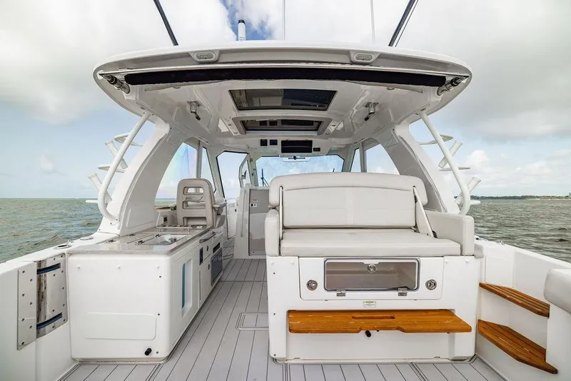 Slide: The Image of 2019 Boston Whaler 380 Realm boat interior with seating and ocean view. - 9