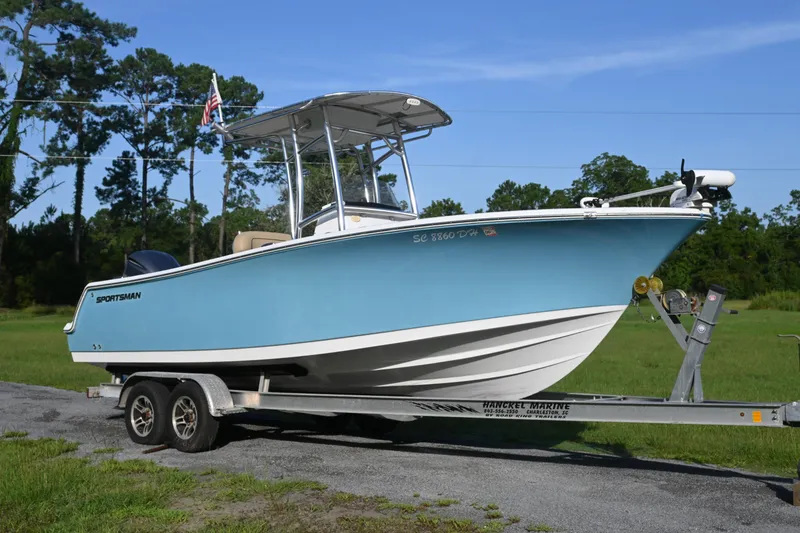 The Image of 2018 Sportsman Open 232 Center Console boat on trailer, parked outdoors. - 0