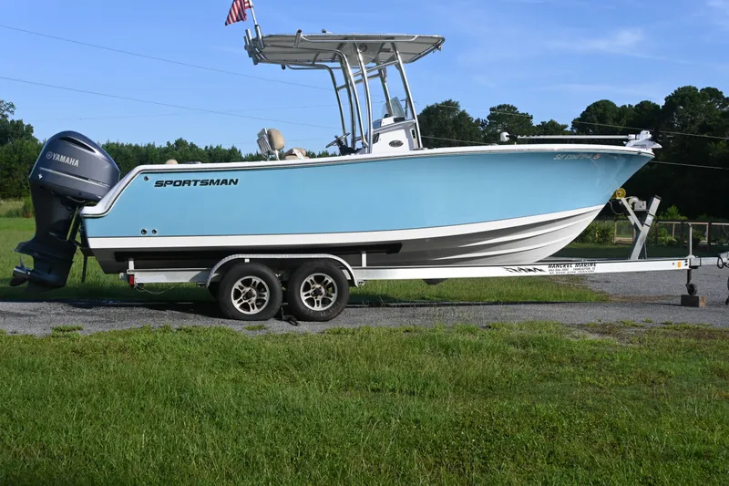 Slide: The Image of 2018 Sportsman Open 232 Center Console boat on trailer, blue hull, Yamaha engine. - 2
