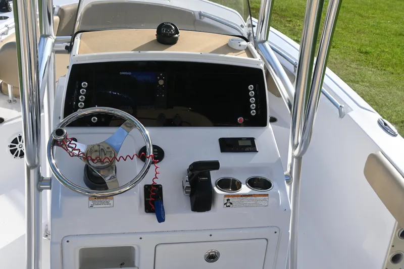 Slide: The Image of 2018 Sportsman Open 232 Center Console boat dashboard with steering wheel and controls. - 5