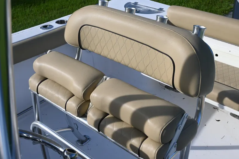 Slide: The Image of 2018 Sportsman Open 232 Center Console boat seating with beige cushioned upholstery. - 7