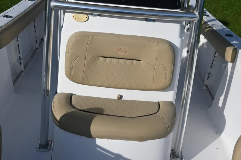 Slide: The Image of 2018 Sportsman Open 232 Center Console boat seat with beige upholstery and stainless steel frame. - 9