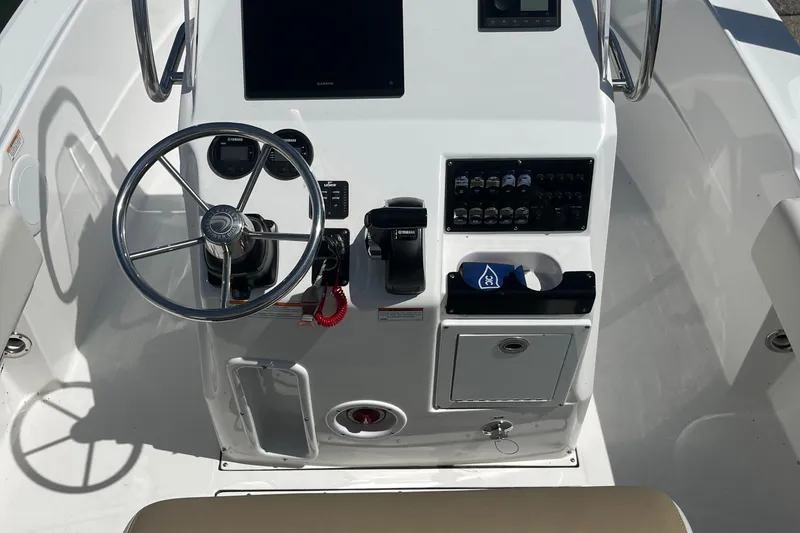 Slide: The Image of 2023 Edgewater 188CC boat console with steering wheel and control panel. - 5
