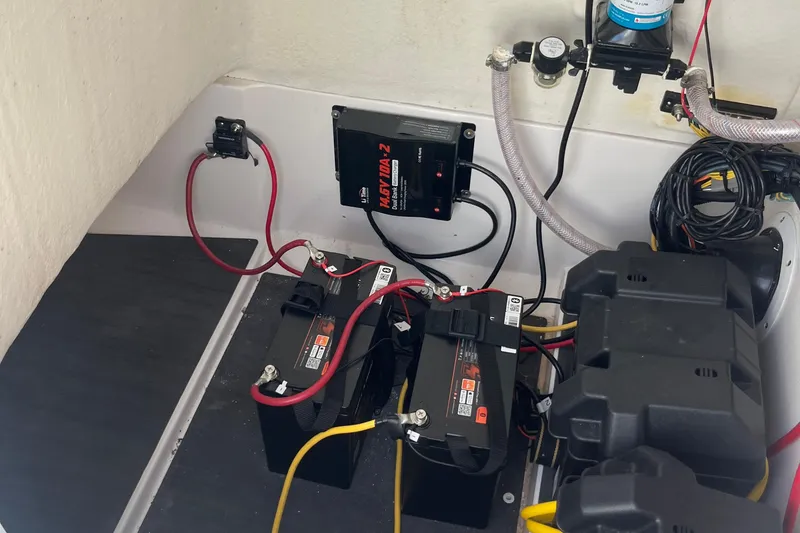Slide: The Image of 2023 Edgewater 188CC boat battery compartment with wiring and components. - 8