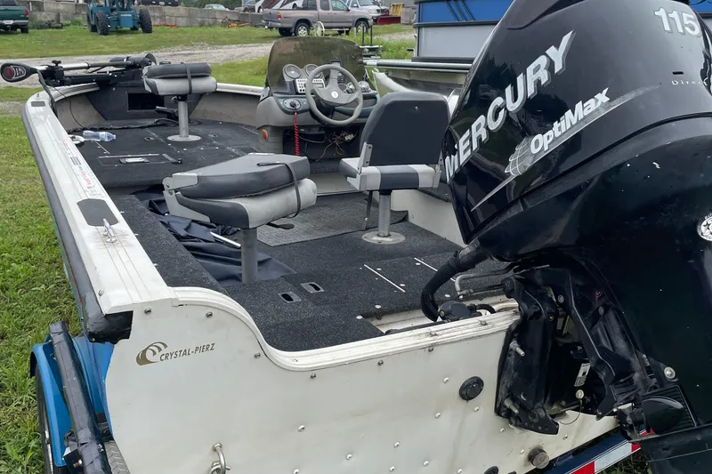 Slide: The Image of 2007 Crestliner Fish Hawk 1750 SC boat with Mercury OptiMax engine, parked on grass. - 6