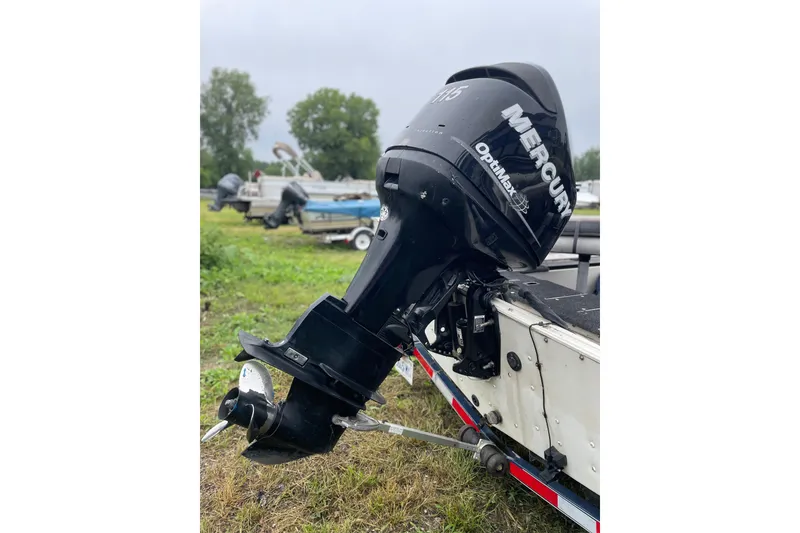 Slide: The Image of 2007 Crestliner Fish Hawk 1750 SC with Mercury OptiMax outboard motor in grassy area. - 8