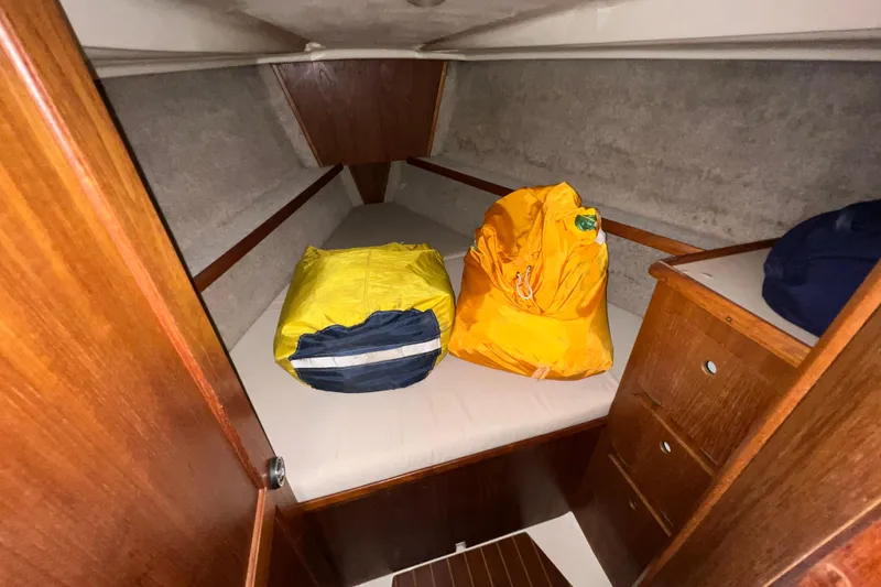 Slide: The Image of Cozy cabin interior of 1988 Hunter 333 sailboat with storage bags on bed. - 13