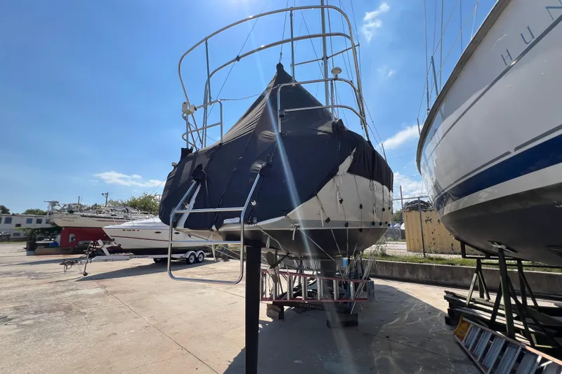 Slide: The Image of 1988 Hunter 333 sailboat on dry dock under clear blue sky. - 3