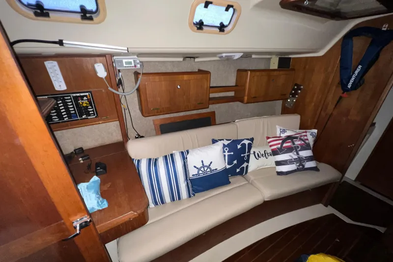 Slide: The Image of Interior of 1988 Hunter 333 sailboat with nautical-themed cushions and wooden cabinetry. - 5