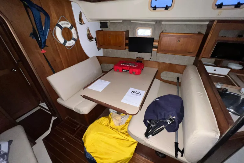 Slide: The Image of Interior of 1988 Hunter 333 sailboat with dining area and nautical decor. - 8