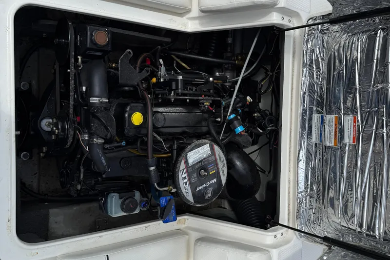 Slide: The Image of Engine compartment of a 2012 Bayliner 175 boat, featuring a MerCruiser engine. - 12