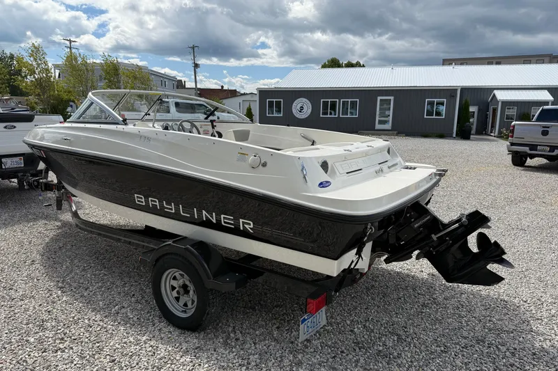 Slide: The Image of 2012 Bayliner 175 boat on trailer, parked outdoors under cloudy sky. - 5