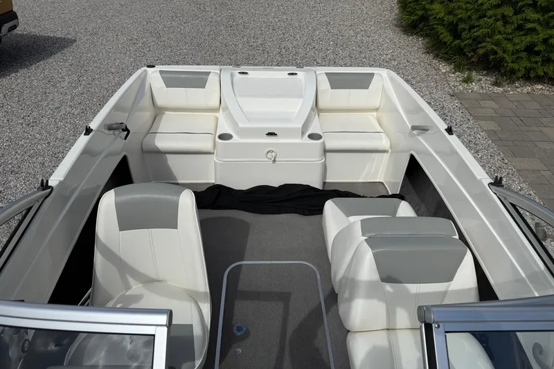 Slide: The Image of 2012 Bayliner 175 boat interior with white seating and gray carpet. - 9